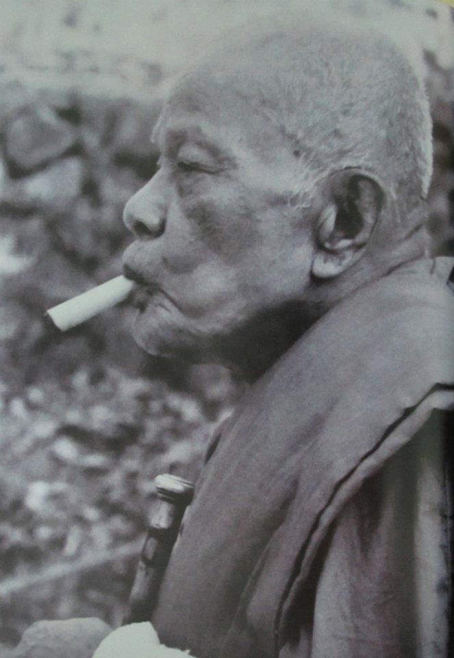 Luang Por Daeng smoikinmg his famous 'Ya Sen' cigar